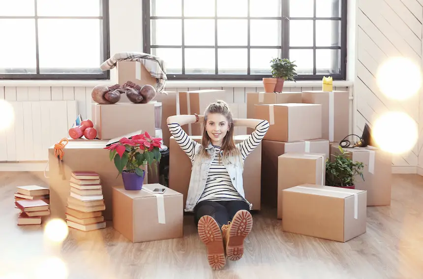 young woman moving in with boxes